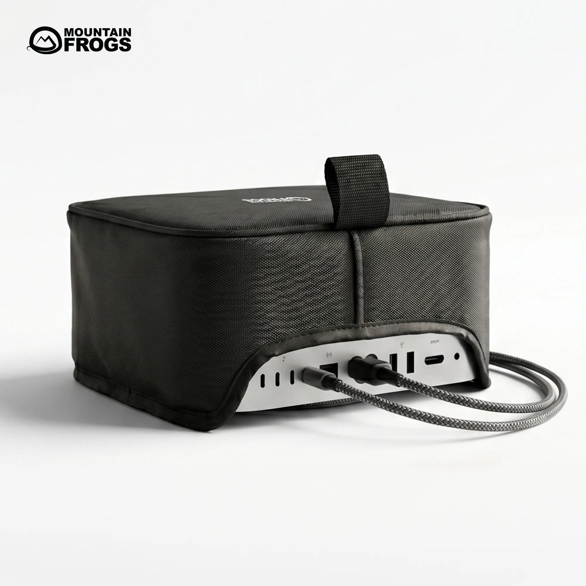Mountain Frogs stealth black dust cover on Apple Mac Studio showing the custom rear cutout with connected cables on a clean white background.